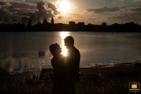 Laghi di Mantova, Italy, provides the stunning backdrop for a dramatic silhouette portrait of the couple, captured a moment before their kiss against the evening skyline.